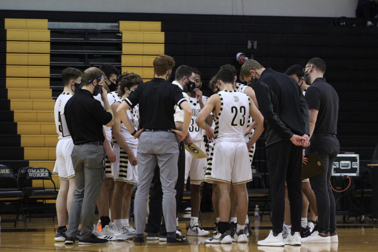 The team huddling up for a pre-game talk before playing Omaha South. Photo by Faith Worden.