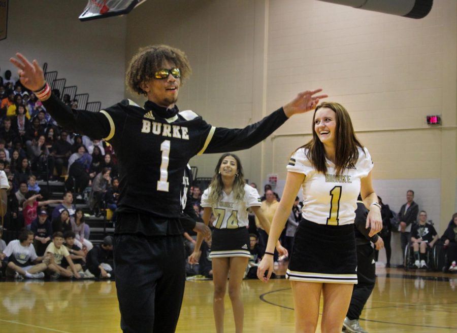 Showing off his moves, senior football player Za'kye Parrott dances with partner and senior cheerleader Caylee Dougherty during an entertaining performance at the pep rally. Varsity football players and cheerleaders were second to perform, taking inspiration from viral TikTok dances.