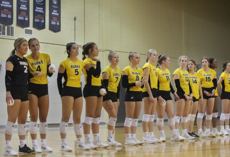 Lining+up+before+being+introduced%2C+the+team+engages+in+pregame+conversation.+Seniors+received+a+small+volleyball+to+throw+to+a+loved+one+when+their+name+was+called+in+honor+of+senior+night.%0APicture+by+Carly+Wilson.