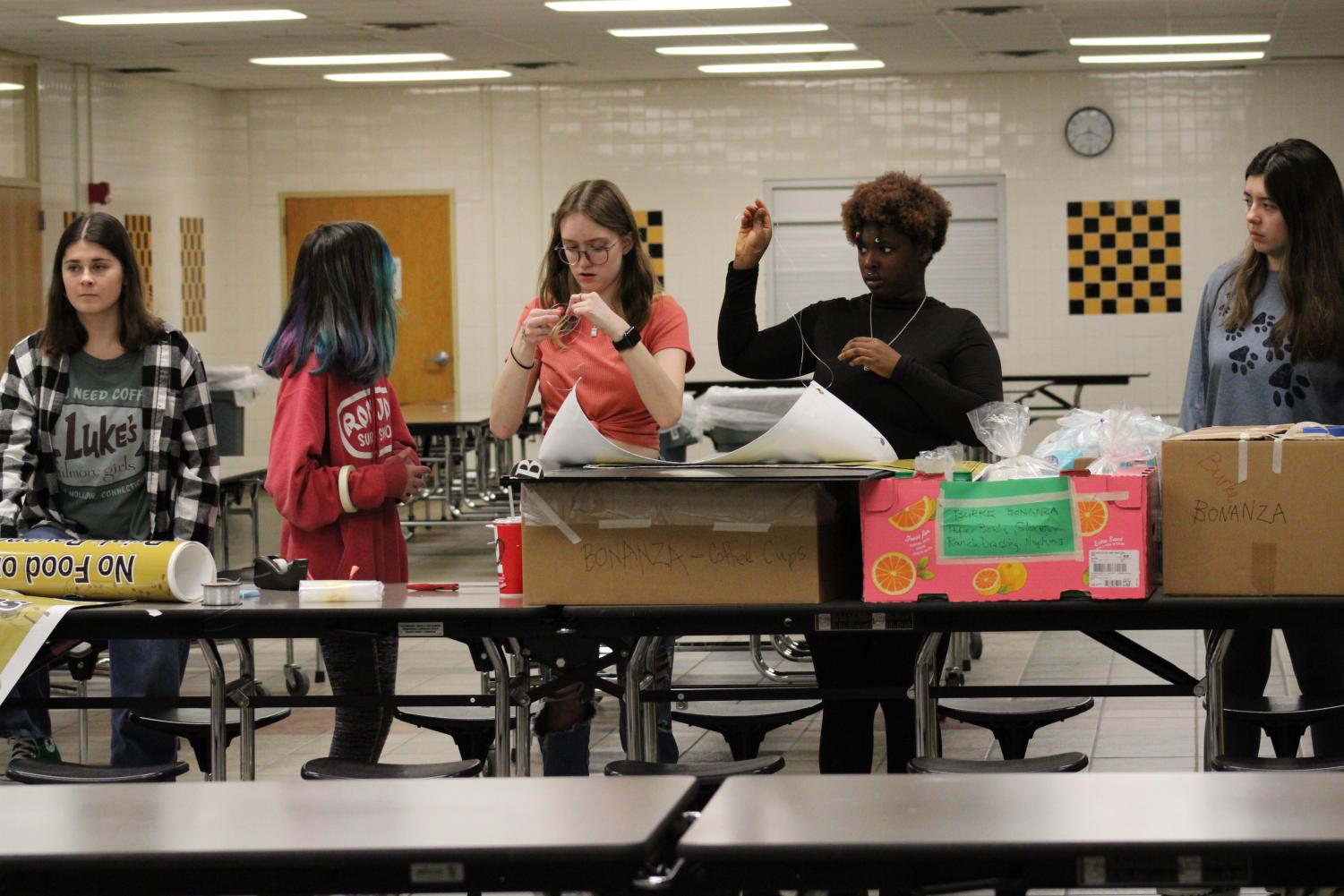 Helpers for Burke Bonanza set up the cafeteria for so that the guests of Burke Bonanza know what to expect for food and beverages.
