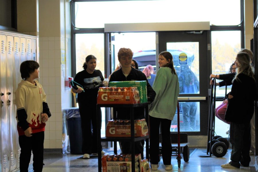 Helpers from Synergy haul dozens of snacks and beverages to serve to the guest that attend Burke Bonanza.