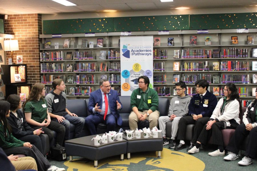 Omaha Bryan students sit in a roundtable discussion in the library with Cardona. They discussed the career academies and pathways and student opportunities that come along with them.