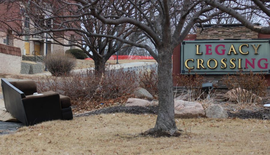 Still sitting next to the Legacy Crossing Apartments sign on Feb. 9, a sofa is abandoned after residents were rushed to move out of the complex when the city condemned the complex in December.