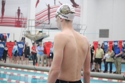 Standing behind the block for the 100 free at State, Jaden Pospishil looks to the other end of the pool remaining calm before he races. 