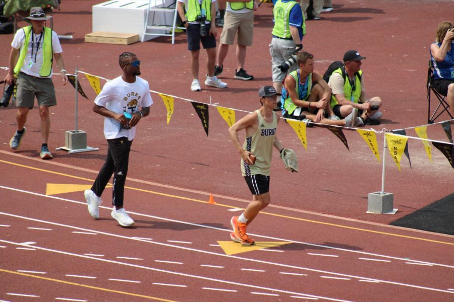 Blake Cerveny (11) and Landon Washington (12) take a few practice laps around the track before the running events begin at the NSAA state track championships on May 17.