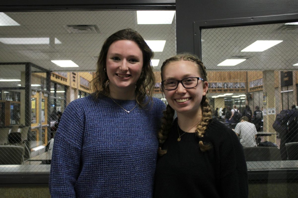 Lea Hanson (left), and Sophia Bouman (right), talk about the Soles4Souls organization this past Tuesday by the cafeteria.