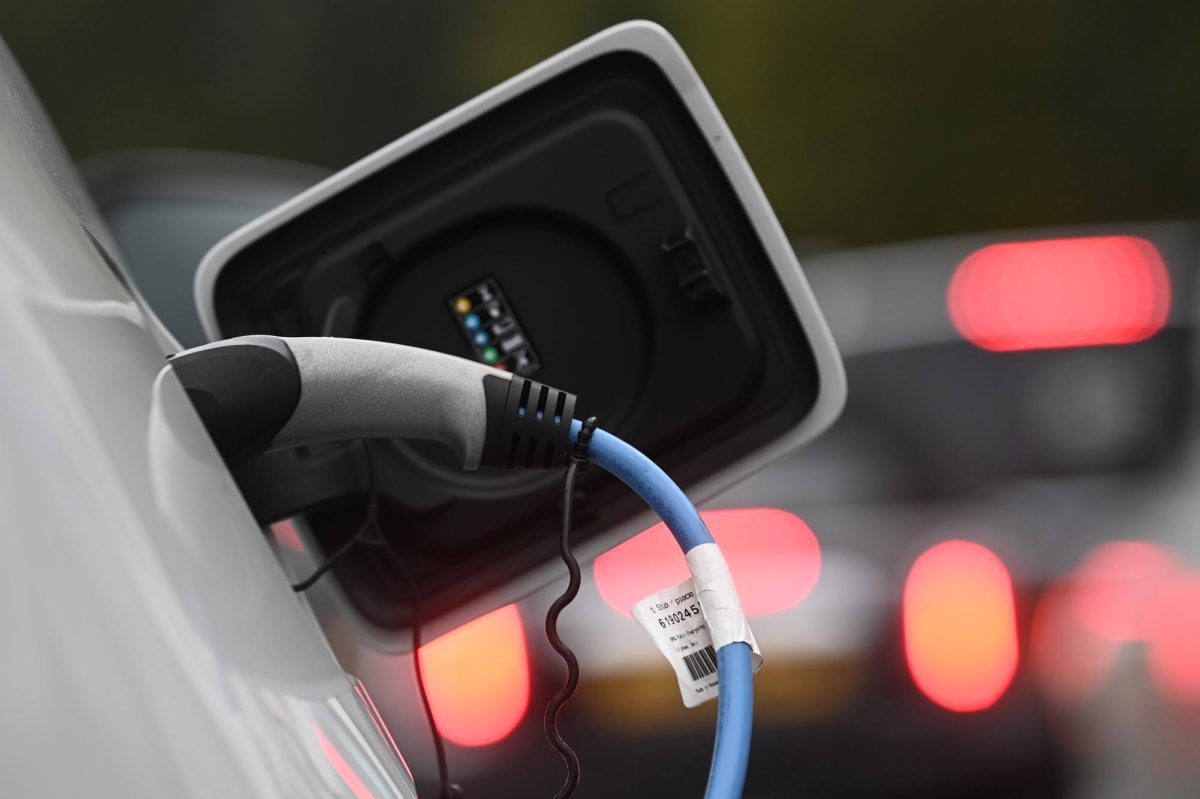 An electric car is charged at a roadside EV charge point, London, October 19, 2021. 
