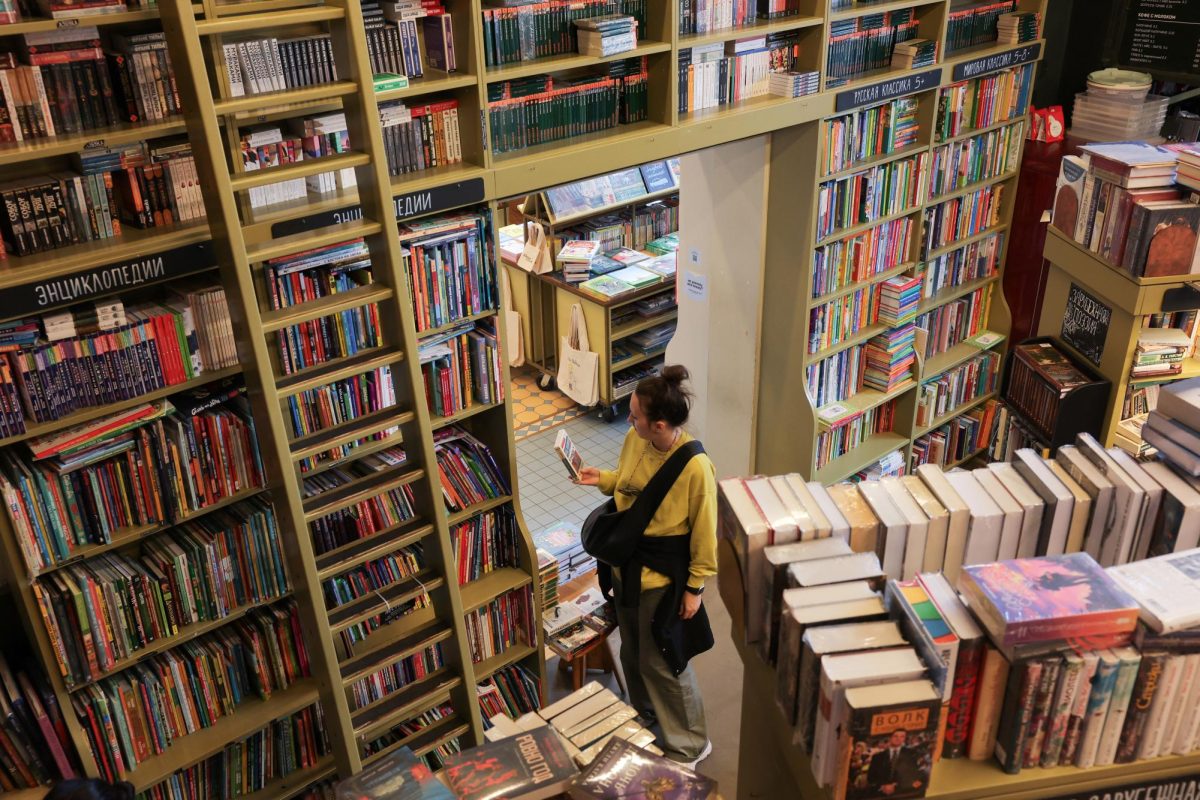 A visitor looks at a book in a bookstore in Saint Petersburg, Russia September 1, 2025. REUTERS/Anton Vaganov