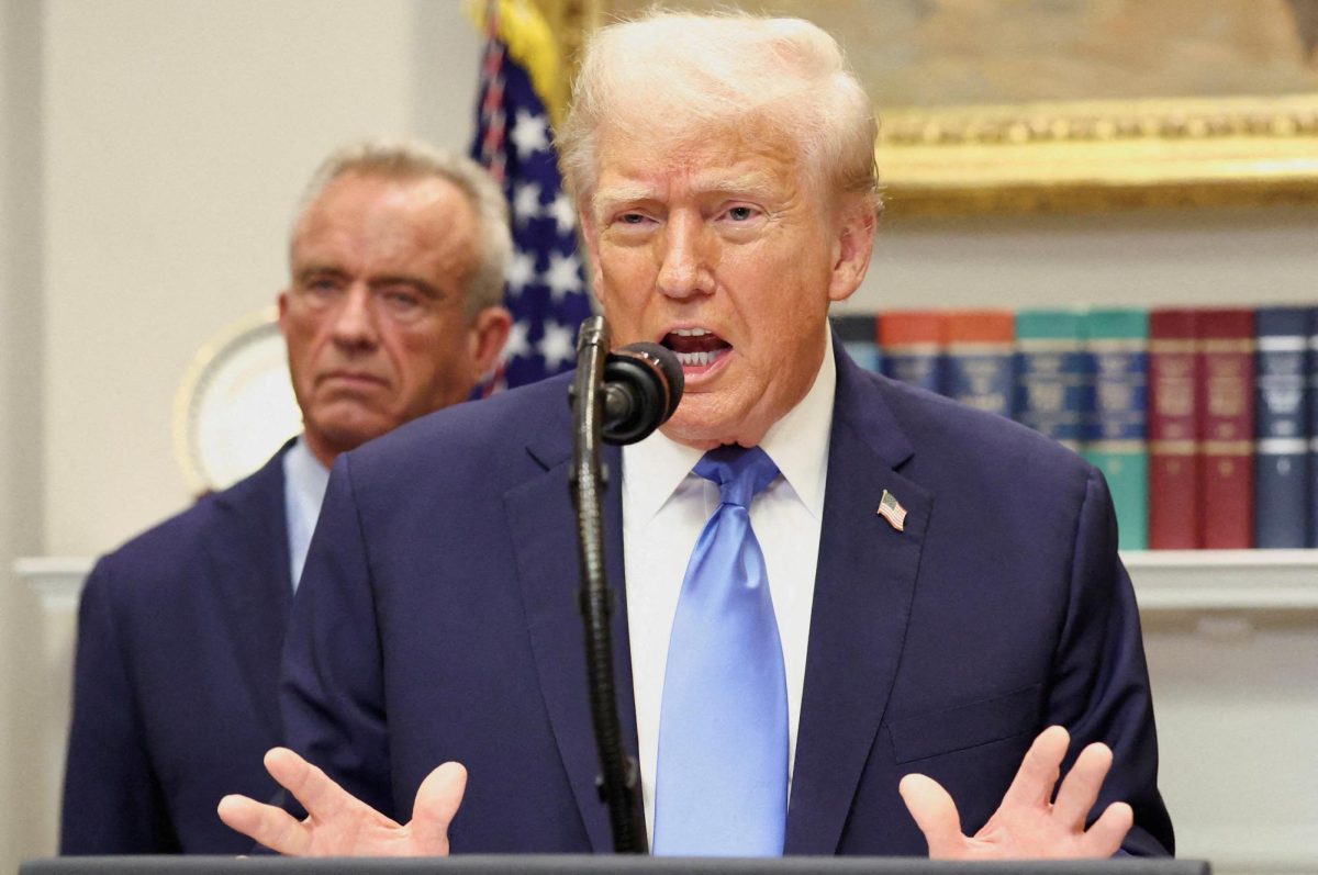 U.S. President Donald Trump, in front of U.S. Secretary of Health and Human Services Robert F. Kennedy Jr., delivers remarks linking autism to childhood vaccines and to the use of popular pain medication Tylenol for pregnant women and children, claims which are not backed by decades of science, at the White House in Washington, D.C., U.S., September 22, 2025. REUTERS/Kevin Lamarque