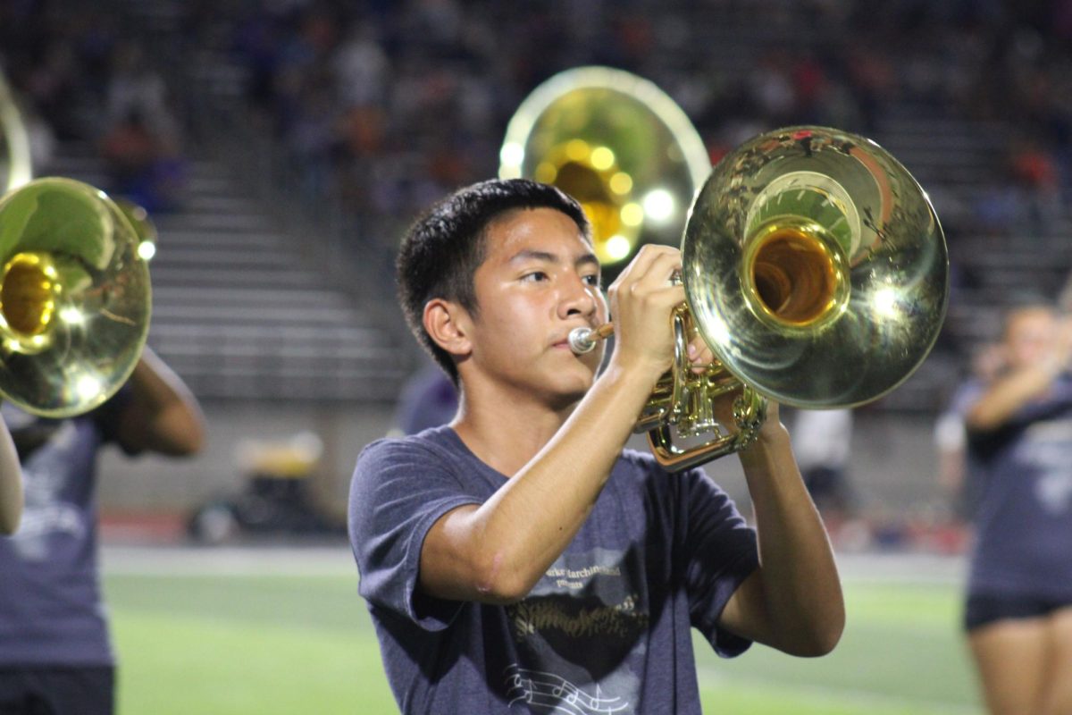 Adan Rasgado (10) avidly plays the mellophone for the band peformance during football halftime show. 