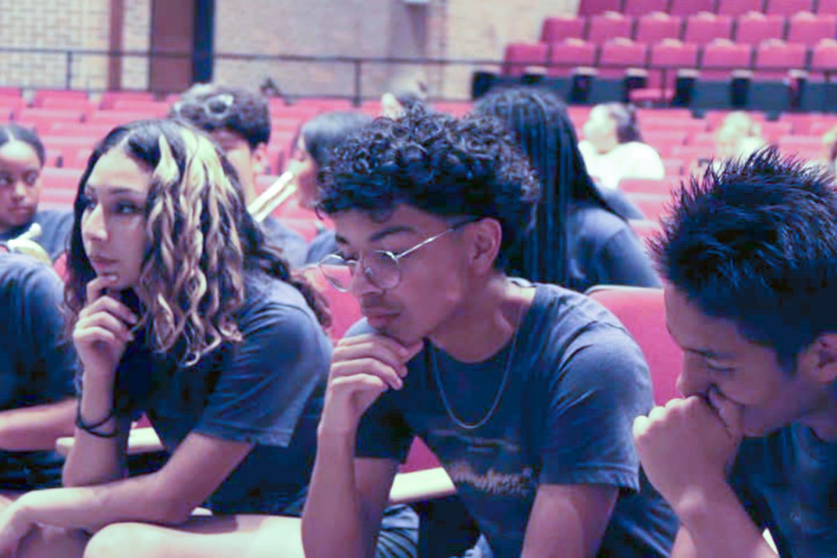 Burke students sit in disappointment after learning the Omaha Marching Exhibition was canceled due to severe weather.