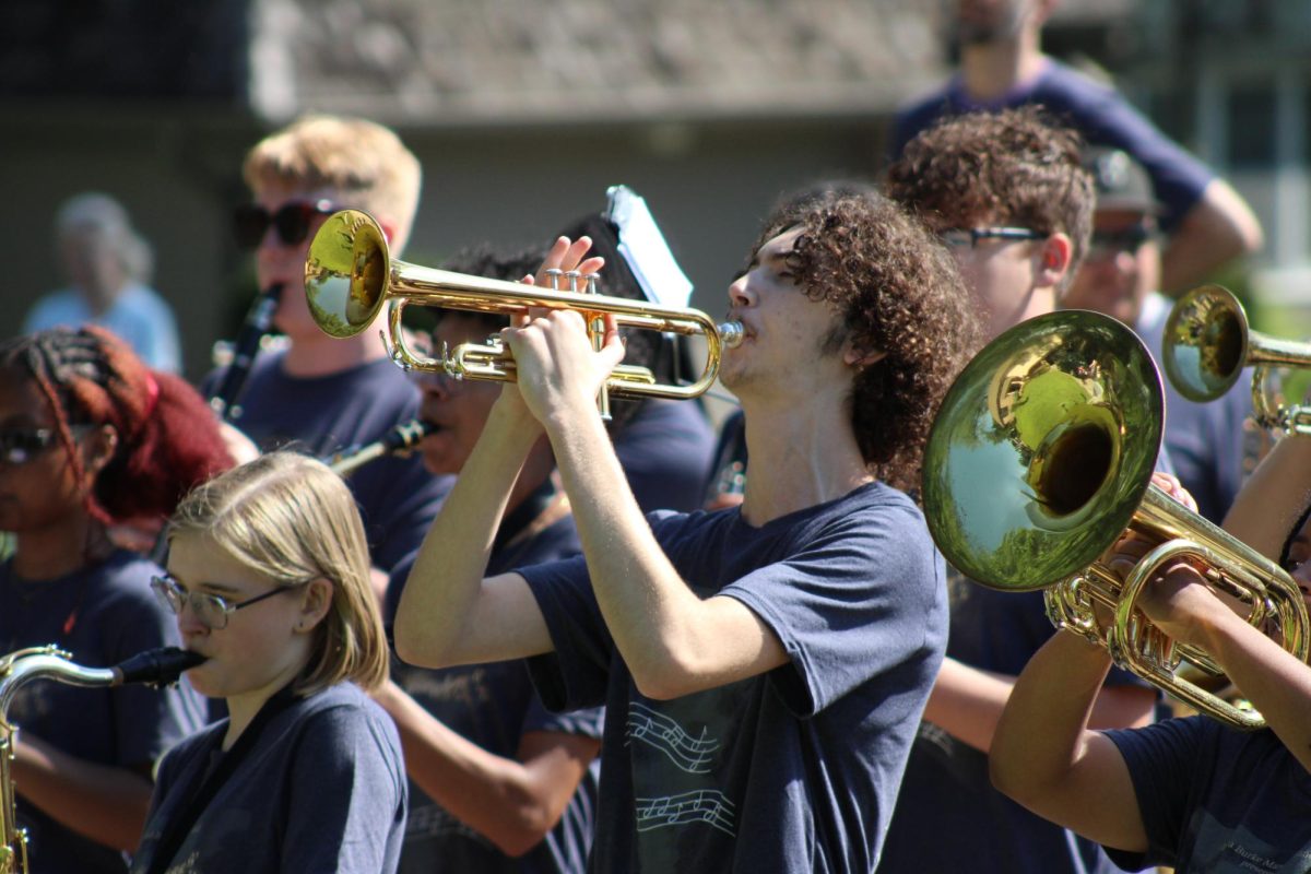 Julian Seney (10) plays the trumpet during a standstill performance for a Burke Band donor