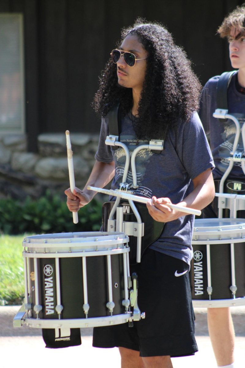 Angel Jimenez (12) plays the snare in a standstill performance for a Burke Band donor