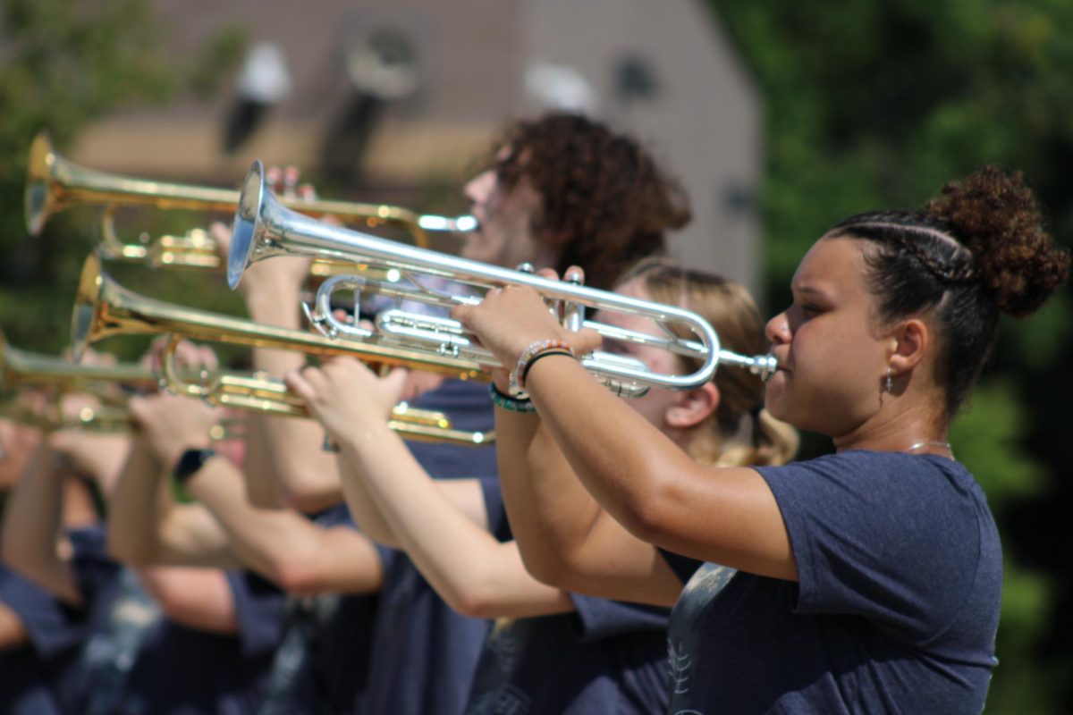 Dayvie White (12) plays the trumpet with the Burke ensemble during their March-A-Thon performance.