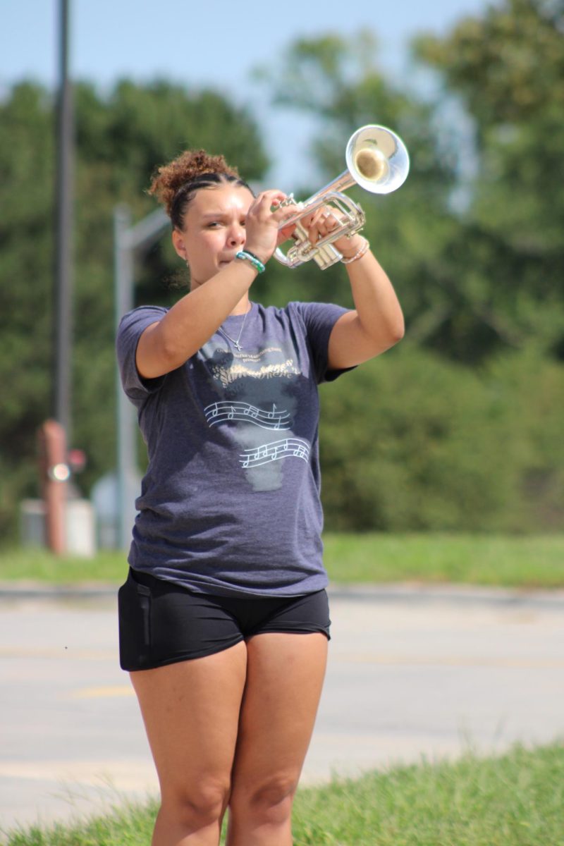 Senior Dayvie White shows her spirit and pride while playing trumpet during march-a-thon. 
