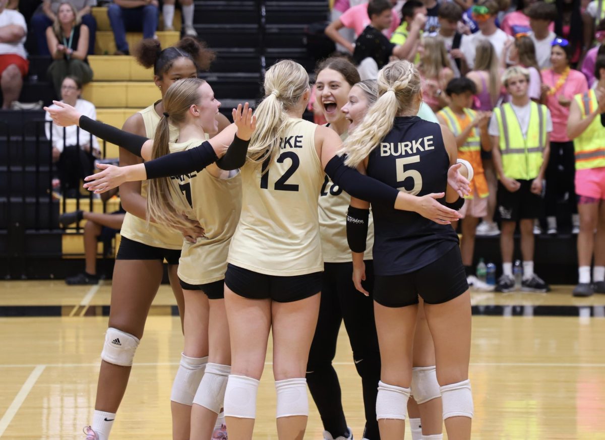 Audrey Bassett (Senior) and Lauren Raduechel (Senior) Celebrates With the team after a successful first set against Roncali In the Dog Pound.