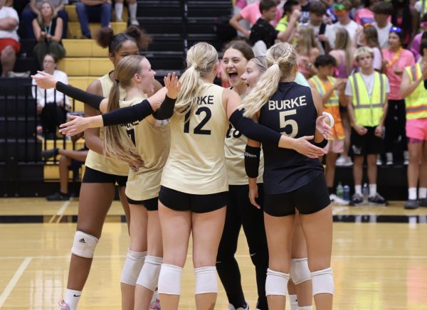 Audrey Bassett (Senior) and Lauren Raduechel (Senior) Celebrates With the team after a successful first set against Roncali In the Dog Pound.