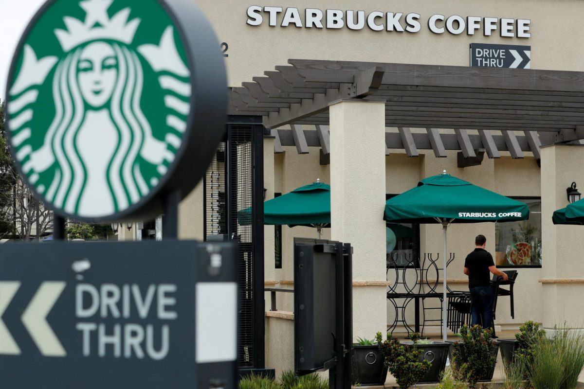 A worker puts away patio furniture at a Starbucks Corp drive-through location closes down this afternoon for anti-bias training as the coffee chain closed all 8,000 of their company-owned cafes in the U.S. including this location in Oceanside, California, U,S. May 29, 2018.    REUTERS/Mike Blake