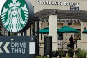 A worker puts away patio furniture at a Starbucks Corp drive-through location closes down this afternoon for anti-bias training as the coffee chain closed all 8,000 of their company-owned cafes in the U.S. including this location in Oceanside, California, U,S. May 29, 2018.    REUTERS/Mike Blake