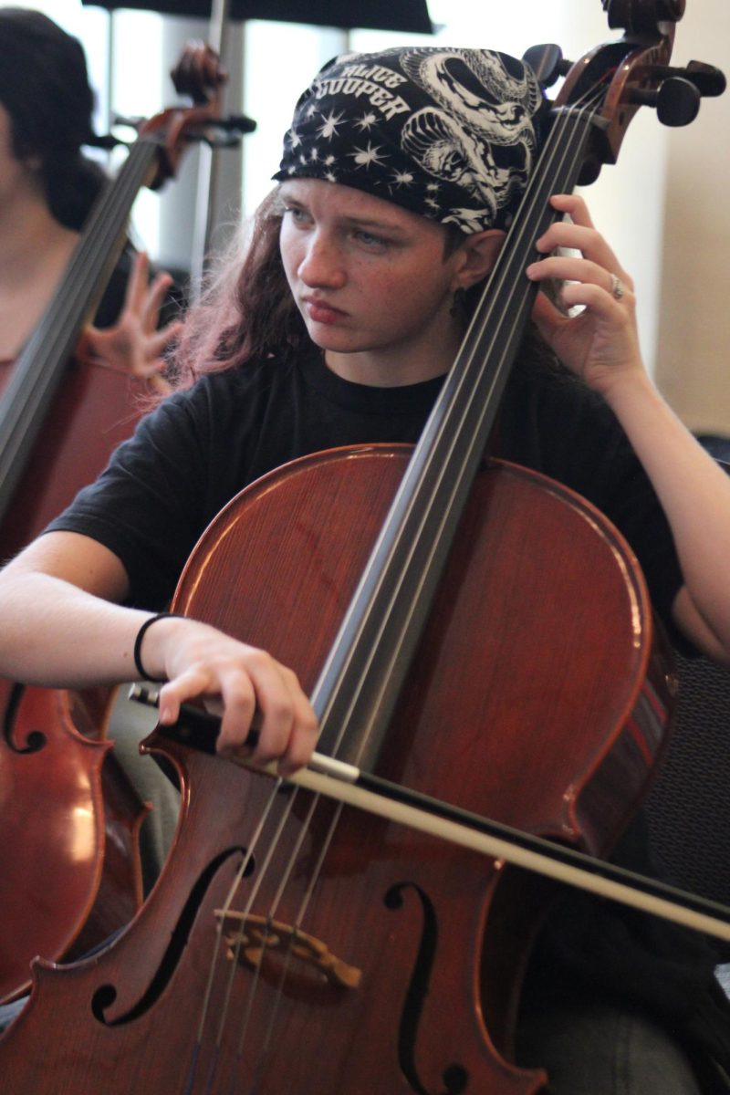 Sophmore Emma West plays her cello, practicing for her performance.