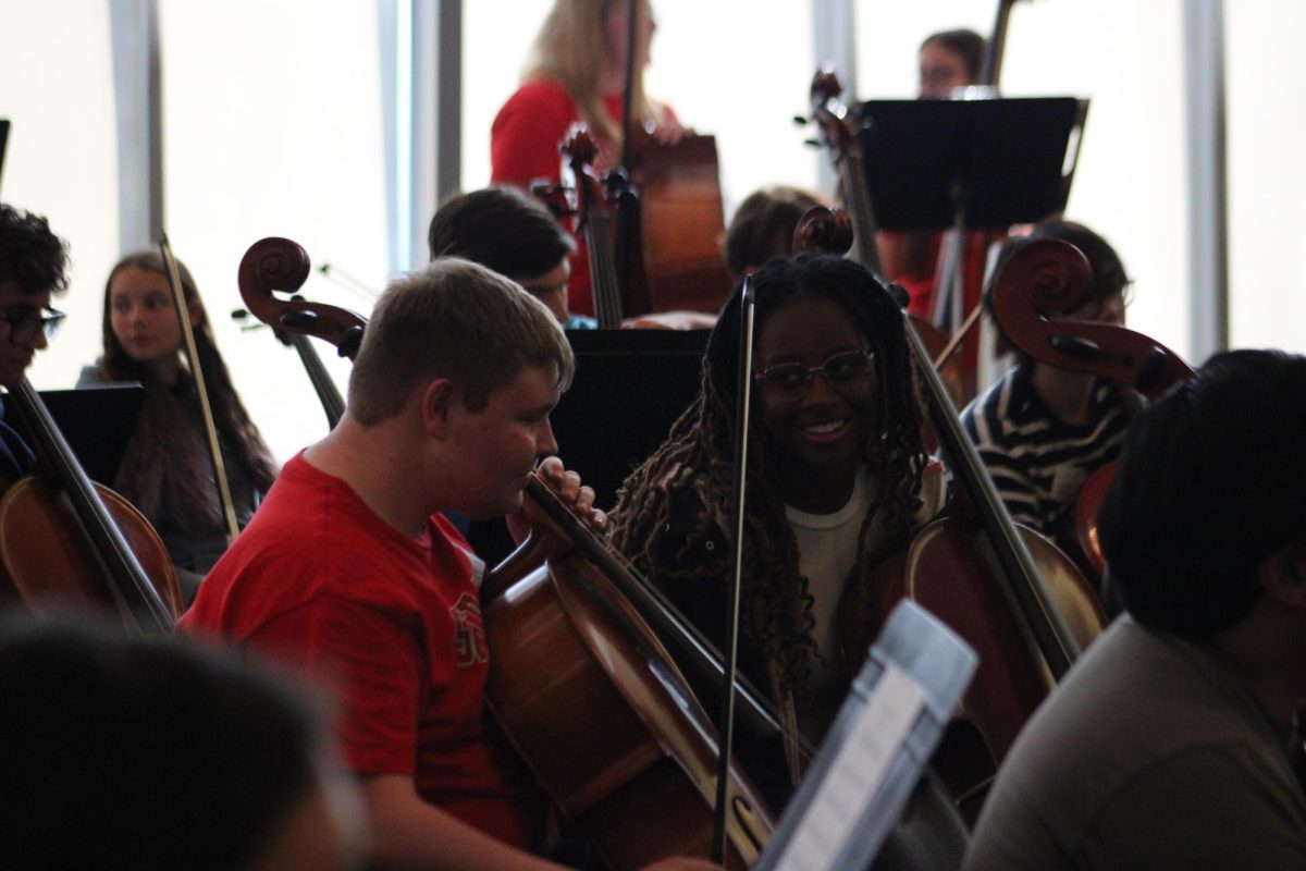 Seniors Jonae Davis and Samuel Ouren conversing during a short break before their cello performance. 