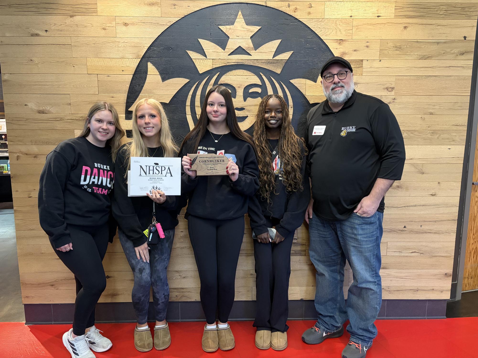 Emily Douglas, Kaci Hirchert, Callie Huffman, Ban Pouch, and Michael Malcom-Bjorklund stand in front of a Starbucks at UNL, after winning the Nebraska Cornhusker Award for the Burke Book.