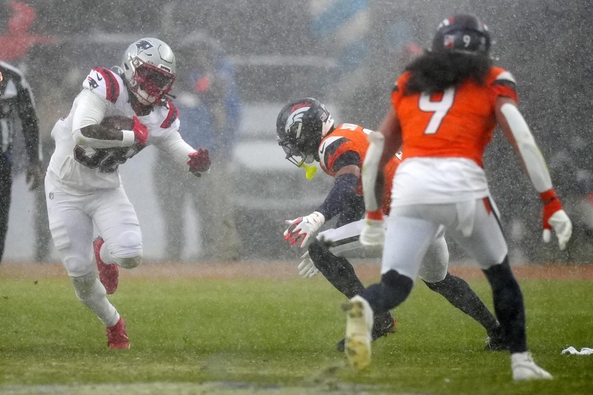 Jan 25, 2026; Denver, CO, USA; New England Patriots running back Rhamondre Stevenson (38) rushes the ball against the Denver Broncos during the second half in the 2026 AFC Championship Game at Empower Field at Mile High. Mandatory Credit: Ron Chenoy-Imagn Images