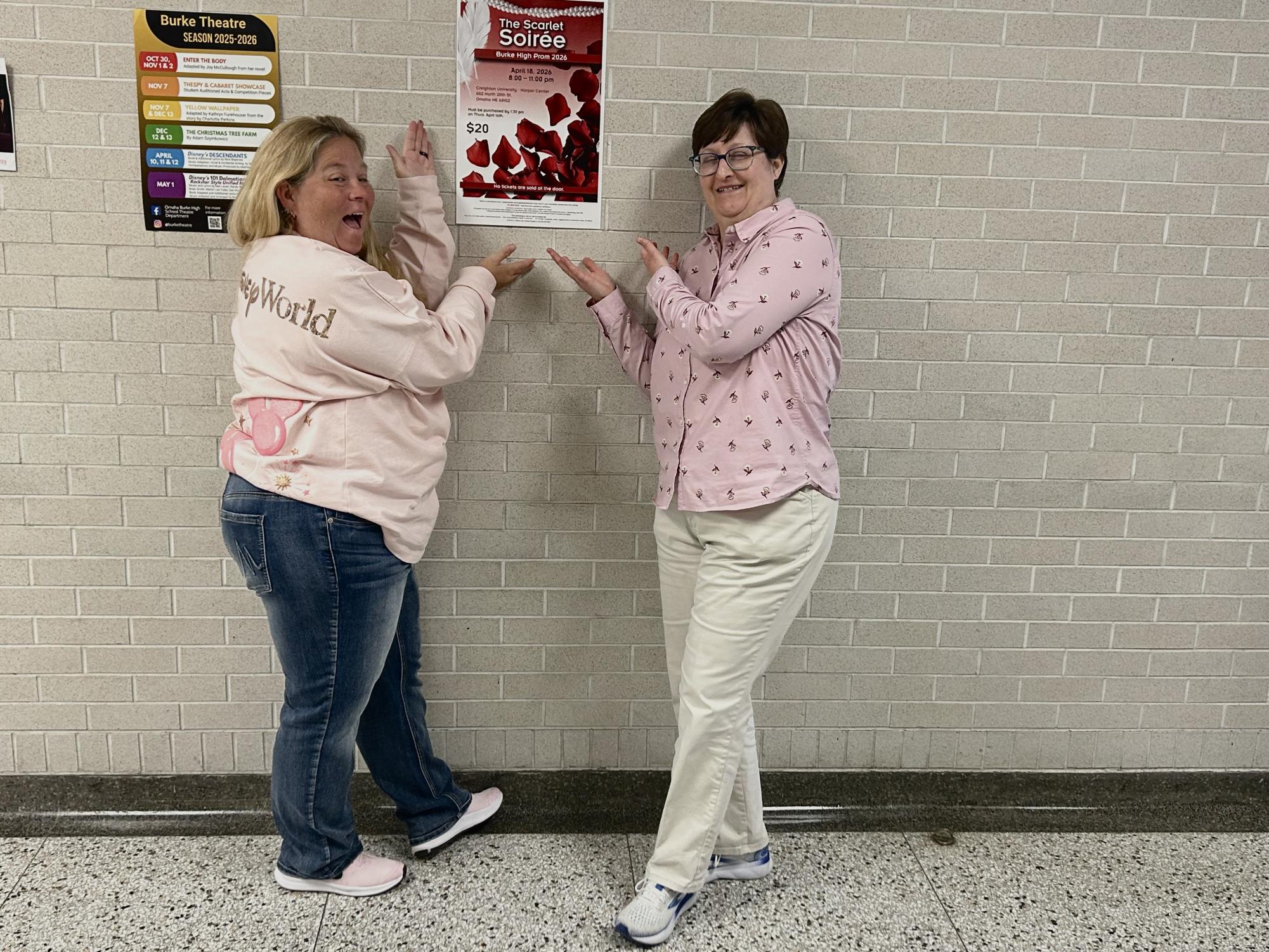 Ms. Ludwig and Ms. Burton posing while showing off the prom poster.