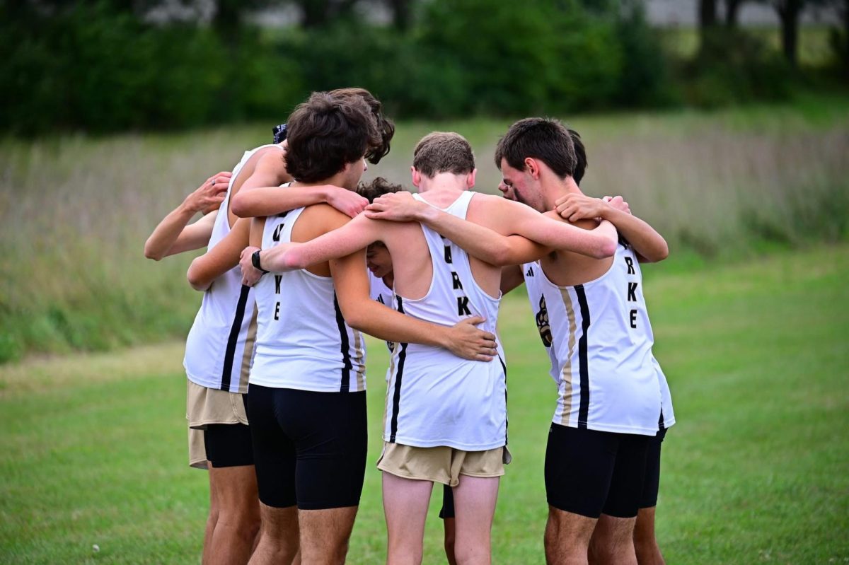 Team huddle before a varsity race, locked in and ready, sharing one last moment of focus, energy, and unity before giving it everything out on the course
