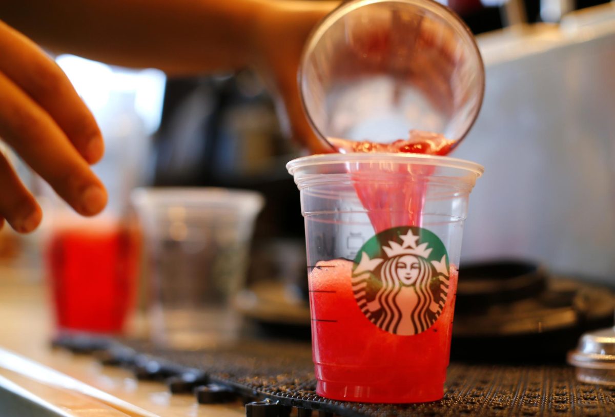 A barista pours a drink at a newly designed Starbucks coffee shop in Fountain Valley, California August 22, 2013. REUTERS/Mike Blake