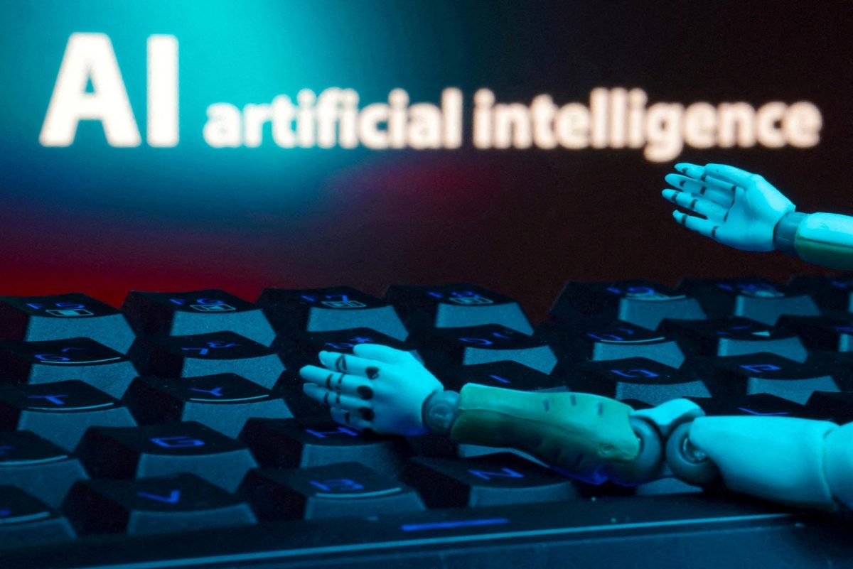 A message reading "AI artificial intelligence," a keyboard and robot hands are seen in this illustration created on January 27, 2025. REUTERS/Dado Ruvic/Illustration