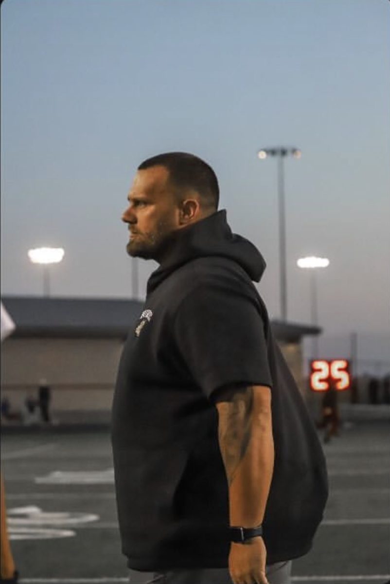 James Patterson preparing to coach before a game.